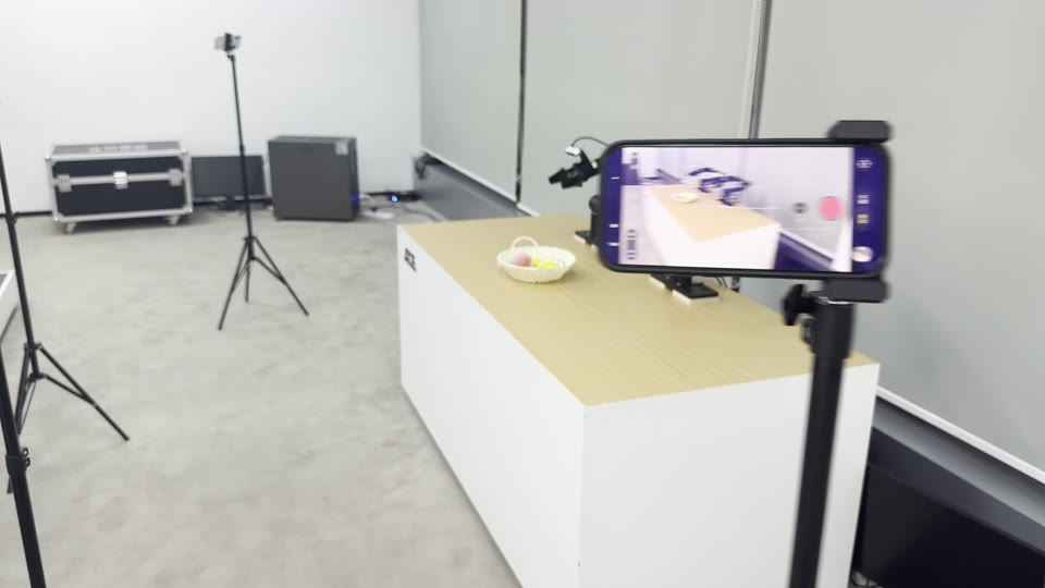 A phone on a stand filming the two arms